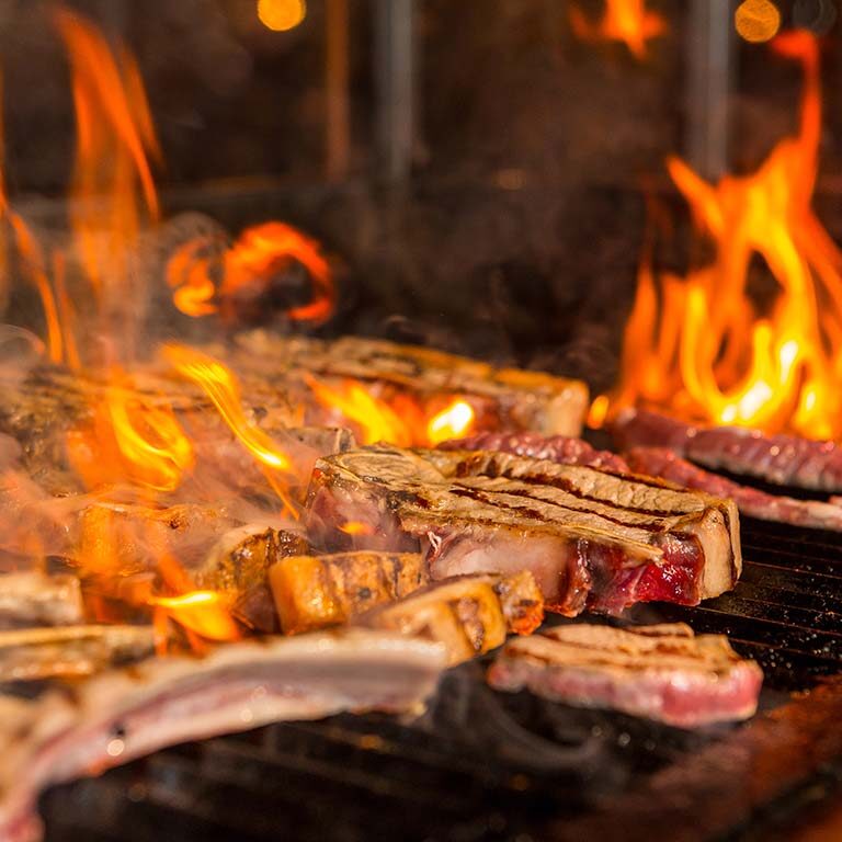 overcooked-meat-steaks-into-flames-grill overcooked-meat-steaks-into-flames-grill