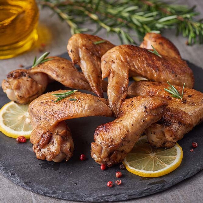 roasted-chicken-wings-barbecue-sauce-with-pepper-seeds-rosemary-salt-black-stone-plate-gray-stone-table-top-view-with-copy-space roasted-chicken-wings-barbecue-sauce-with-pepper-seeds-rosemary-salt-black-stone-plate-gray-stone-table-top-view-with-copy-space